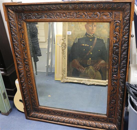 A carved oak wall mirror, W.106cm